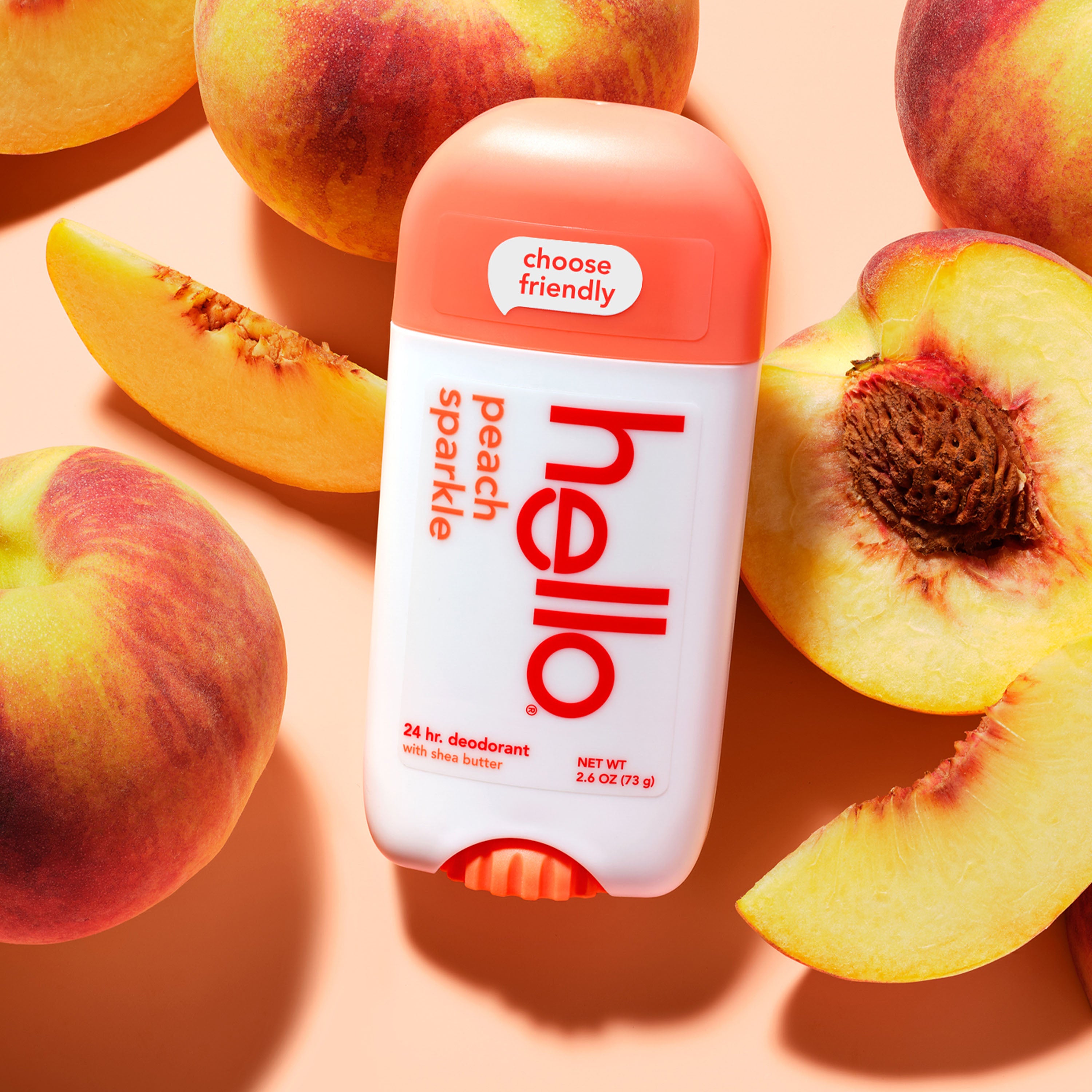 hello peach sparkle aluminum free deodorant with shea butter against a background of peaches. 