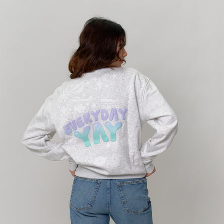 back view of woman wearing hello products grey “everyday yay” sweater with graphic print