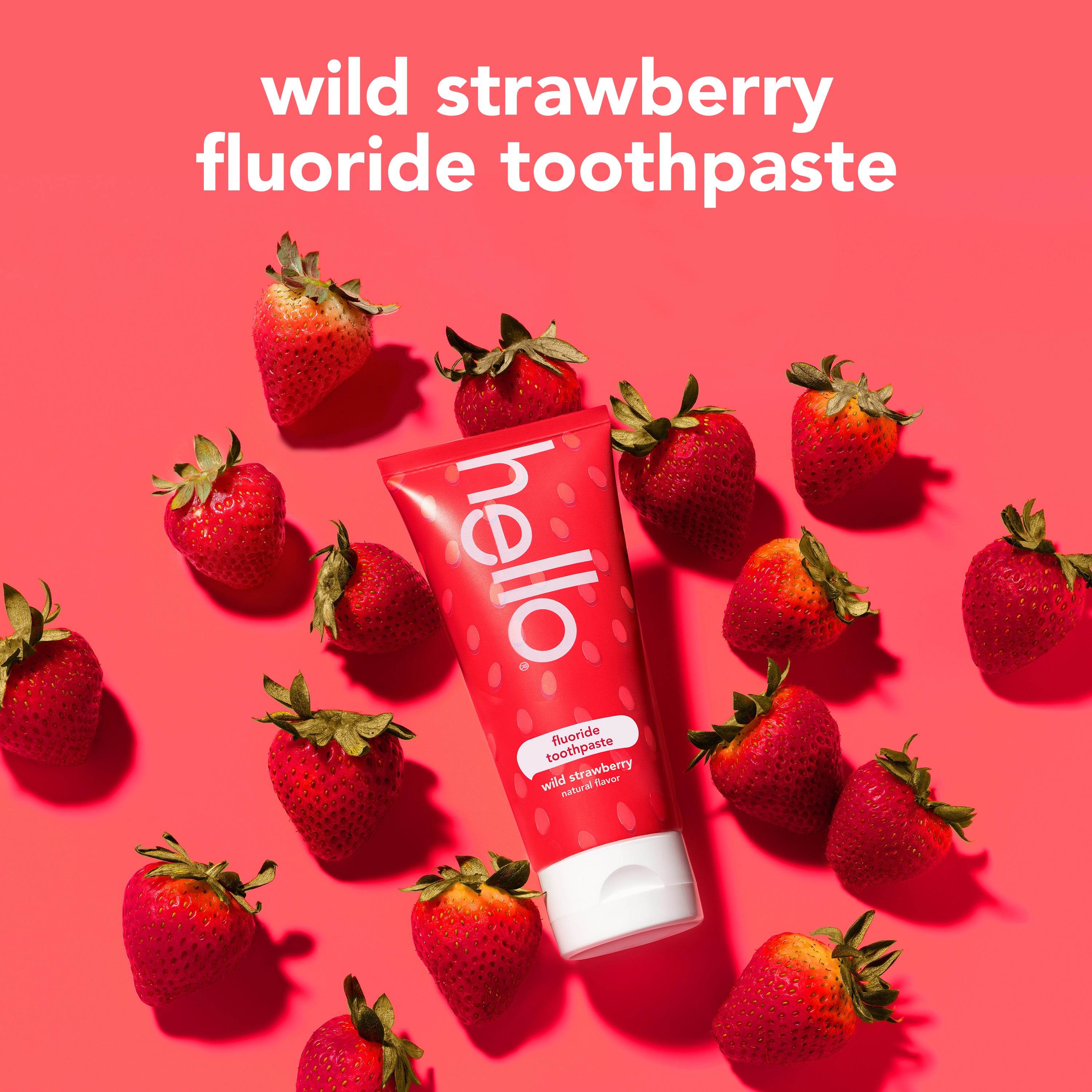 hello kids natural wild strawberry fluoride toothpaste against a background of strawberries. In text: Wild strawberry fluoride toothpaste. 