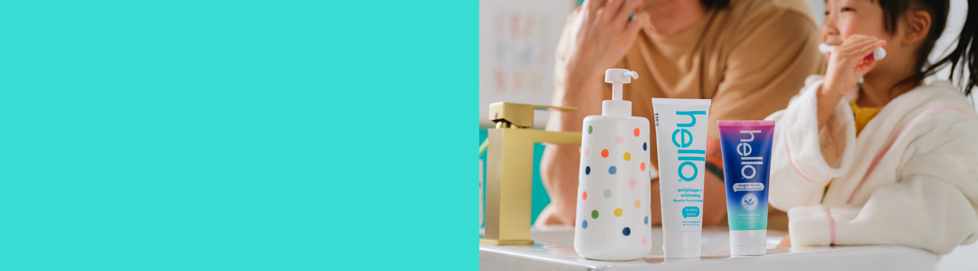 Father and child with 'hello' toothpaste and soap bottles on a bathroom counter.