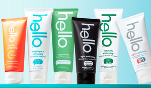 Collection of 'hello' toothpaste tubes in various flavors on a blue background